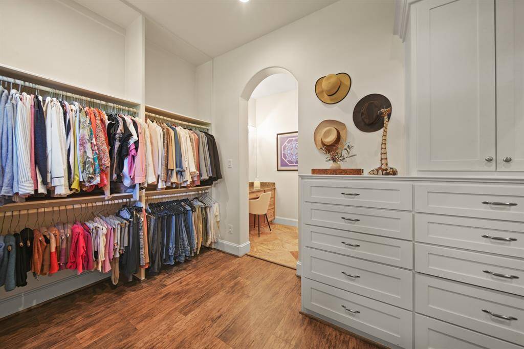 Primary suite includes his and hers closets with built-ins.
