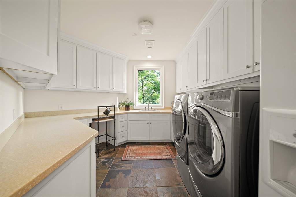 Laundry room with ample storage and counter space.