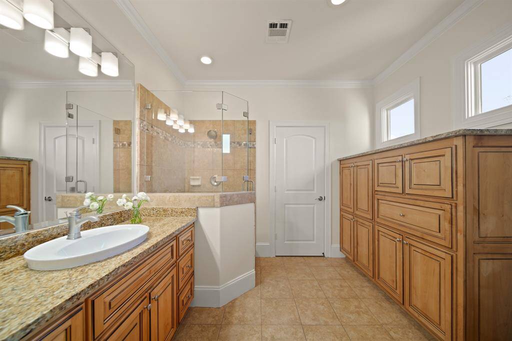 Upstairs ensuite bathroom #1 with shower and built in storage.