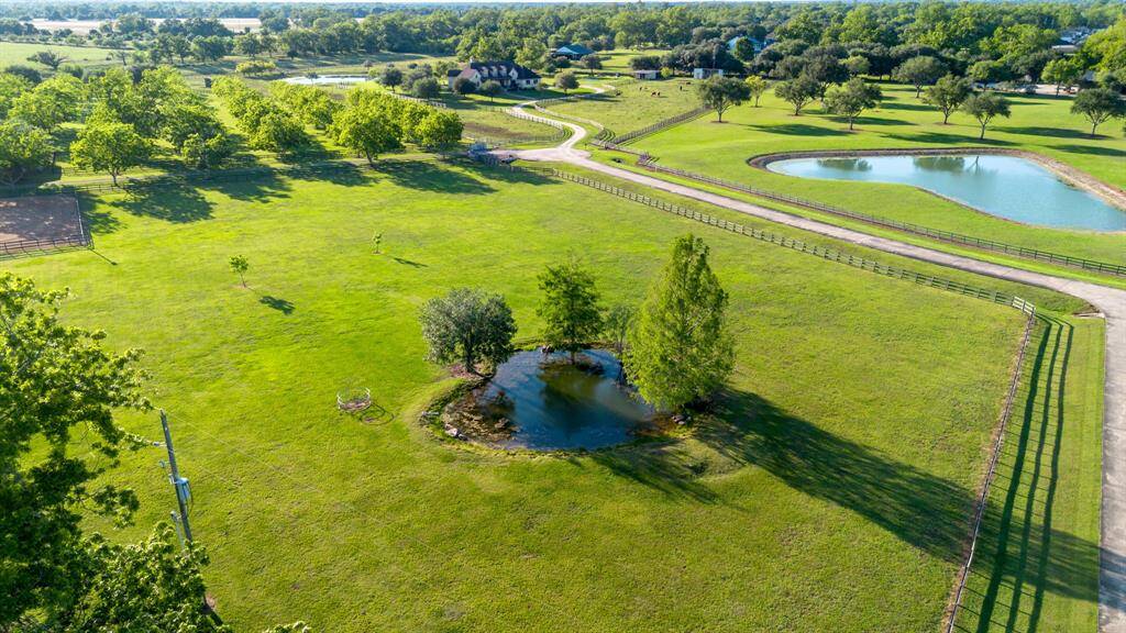 Tranquil private pond with a fenced pasture.
