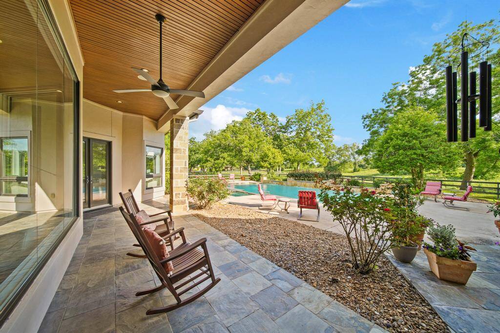 Relaxing porch with scenic views of creek and pasture.