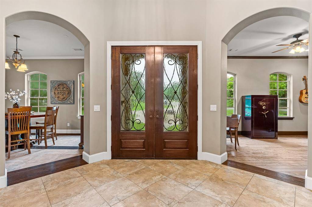 Grand entry with views into the home office and formal dining room.