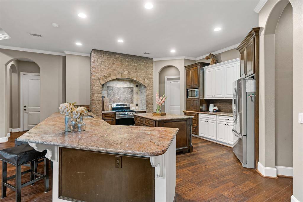 Granite countertops with brick surround of the range.
