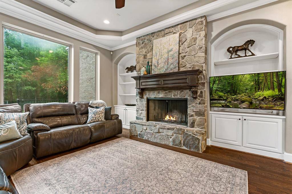 Living area features gas log fireplace and storage on either side.