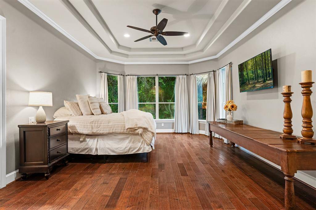 Wood flooring throughout this spacious primary bedroom.