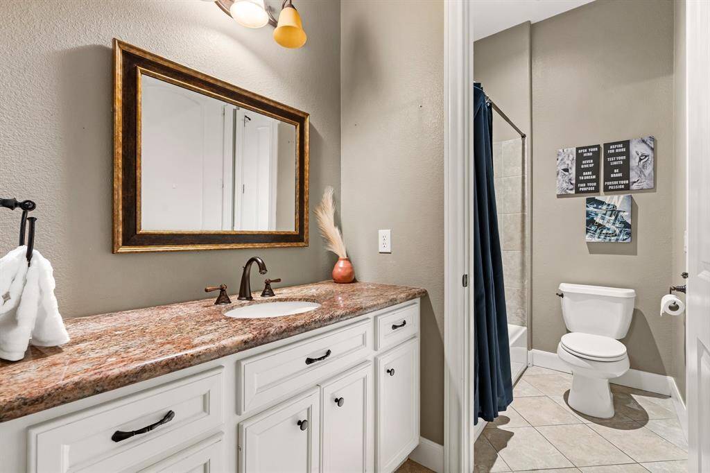 Secondary bathroom features a separate sink area for each bedroom.