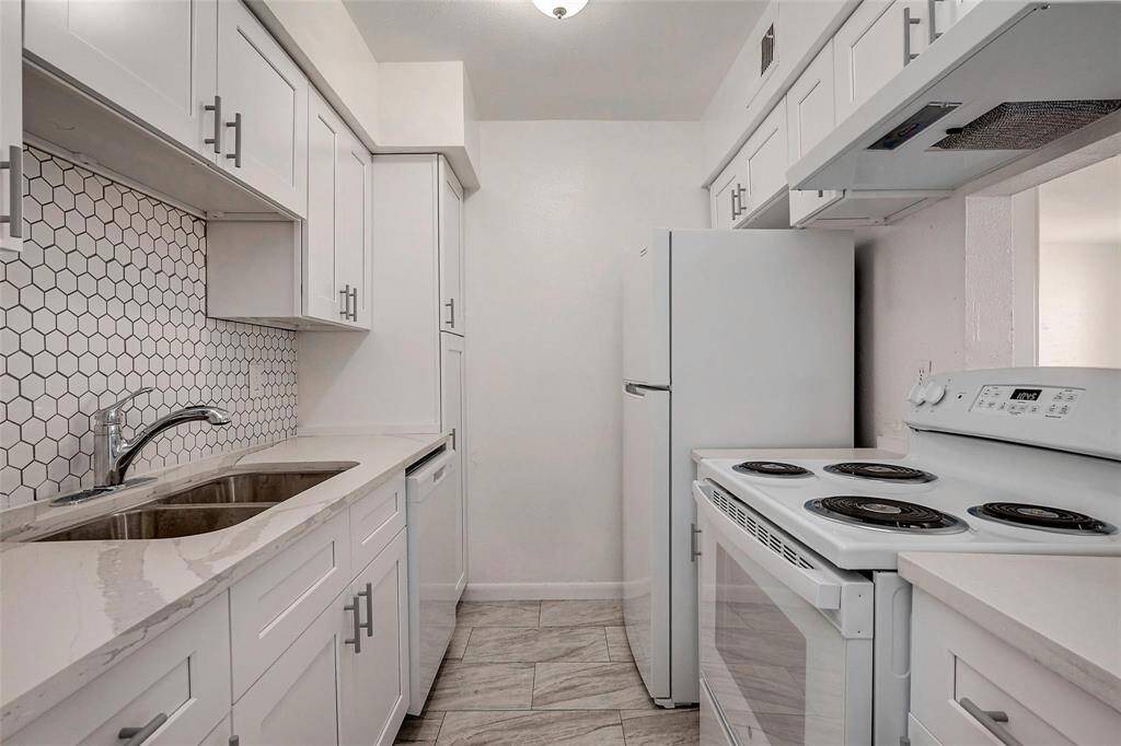 Spectacular beautifully renovated upgraded kitchen with all new appliances, white soft close cabinets and kitchen hood