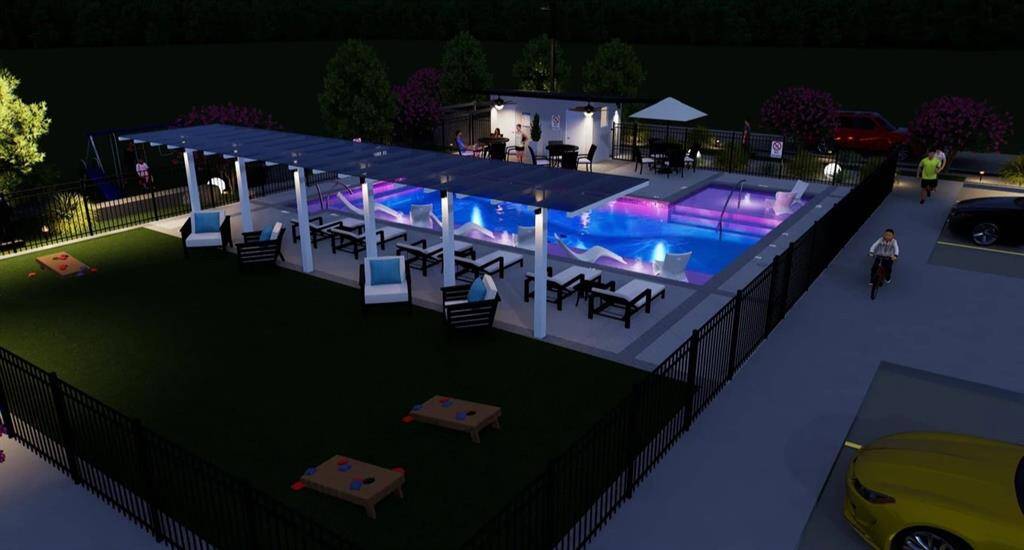 A nighttime view of the community pool and game area For the residents to enjoy.