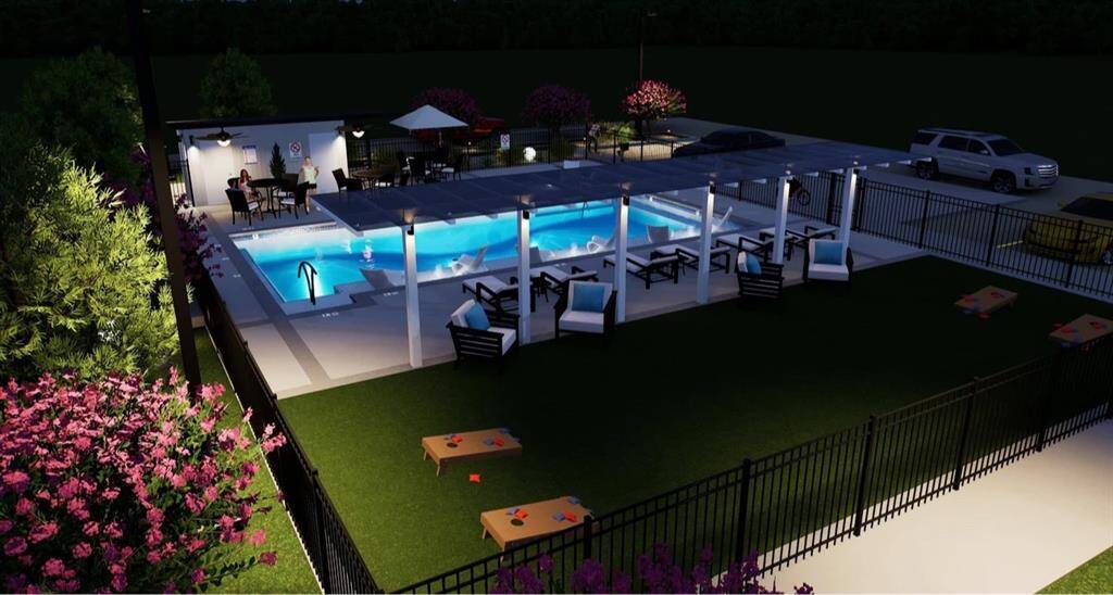 another nighttime view of the community area and pool.