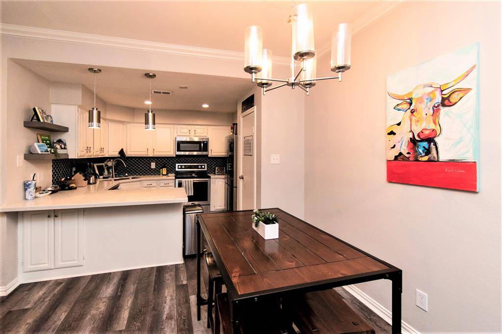 Open concept kitchen with Breakfast bar and dining area, with beautiful pendant lightings
