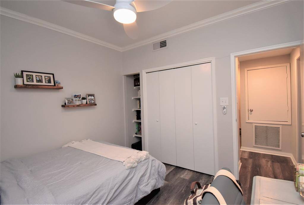 Large built-in closet with accordion door and shelves on the side