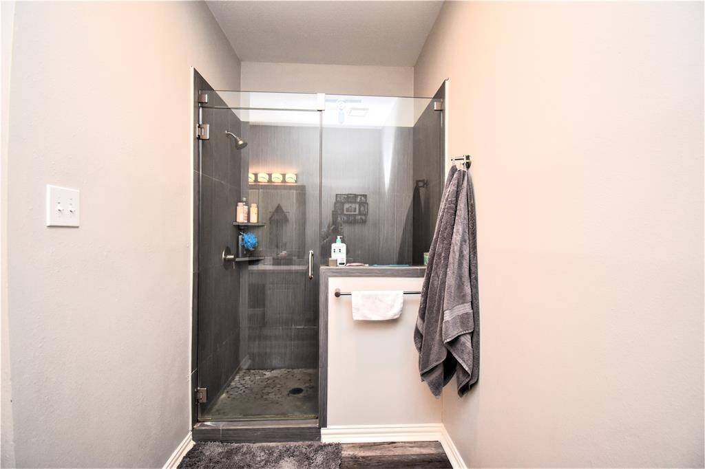 It also has a long bathroom layout and swing glass door shower area.