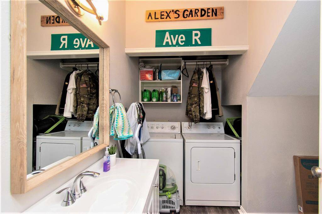 Powder/utility room with washer and dryer. Also have a mirror and lavatory with cabinet.