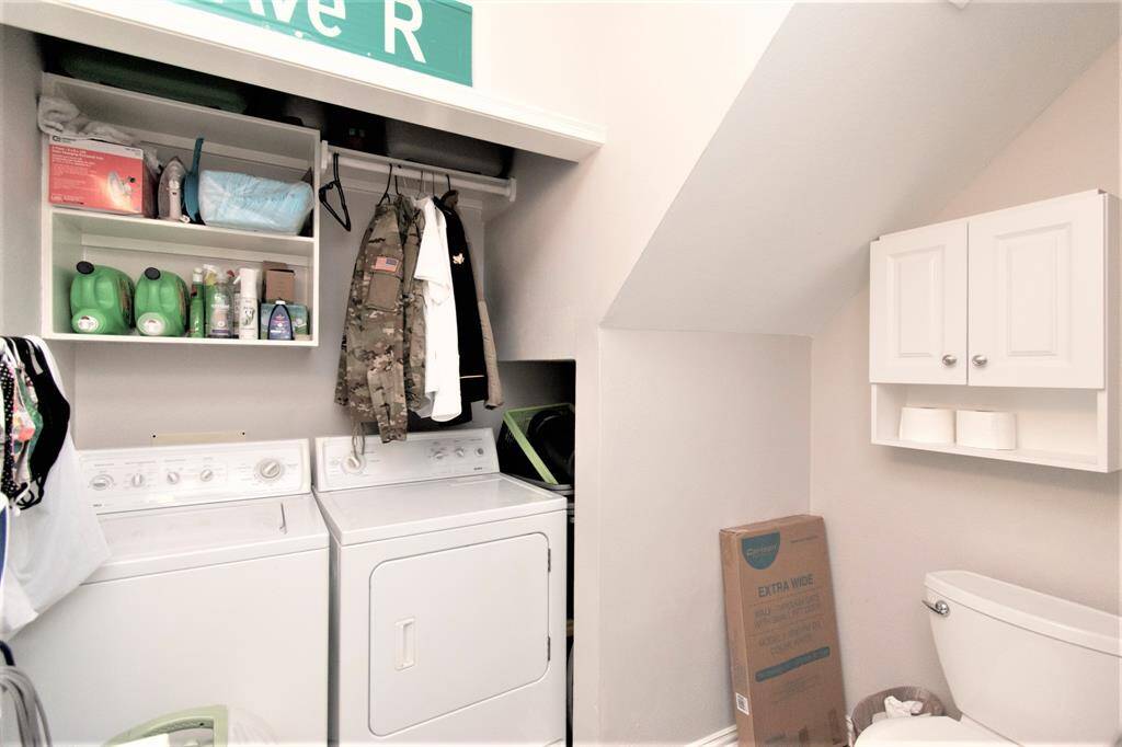 Powder/utility room with washer and dryer.