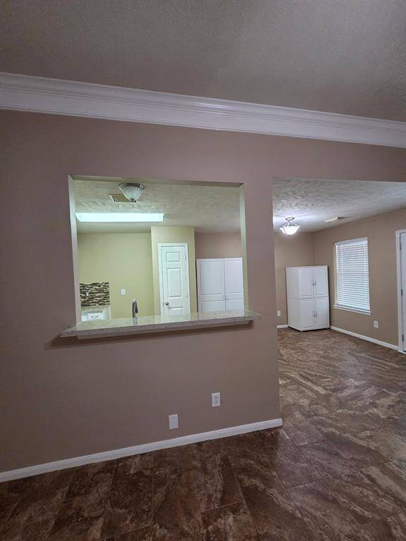 Den looking into kitchen and breakfast room