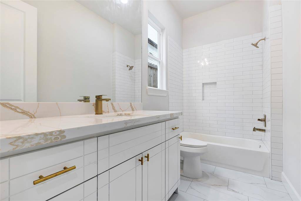 The first floor bathroom features a combo tub and shower.