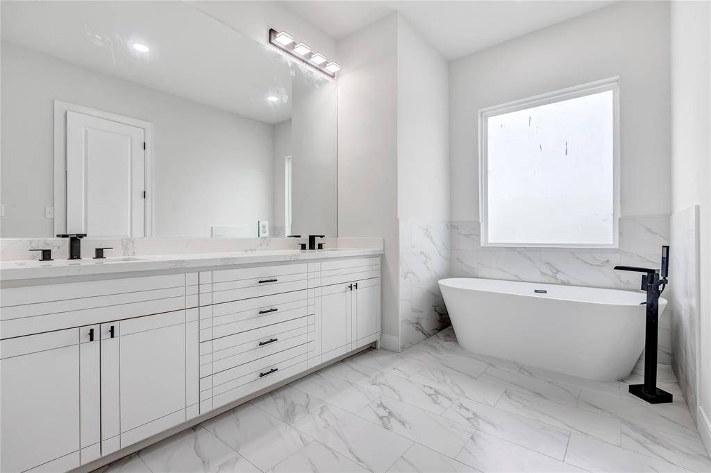 The luxurious freestanding tub is perfect for relaxation.