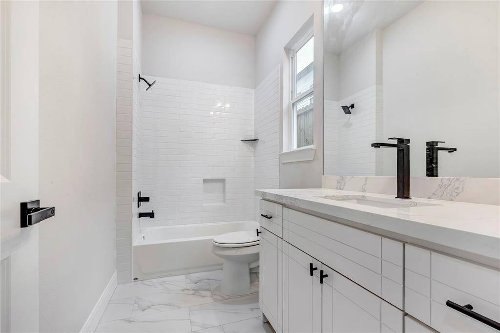 The first floor bathroom features a combo tub and shower.