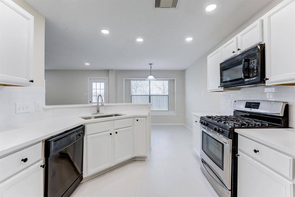 Kitchen Close-UpModern kitchen with updated countertops, white cabinetry, stainless steel gas range, and a window-lined breakfast nook.