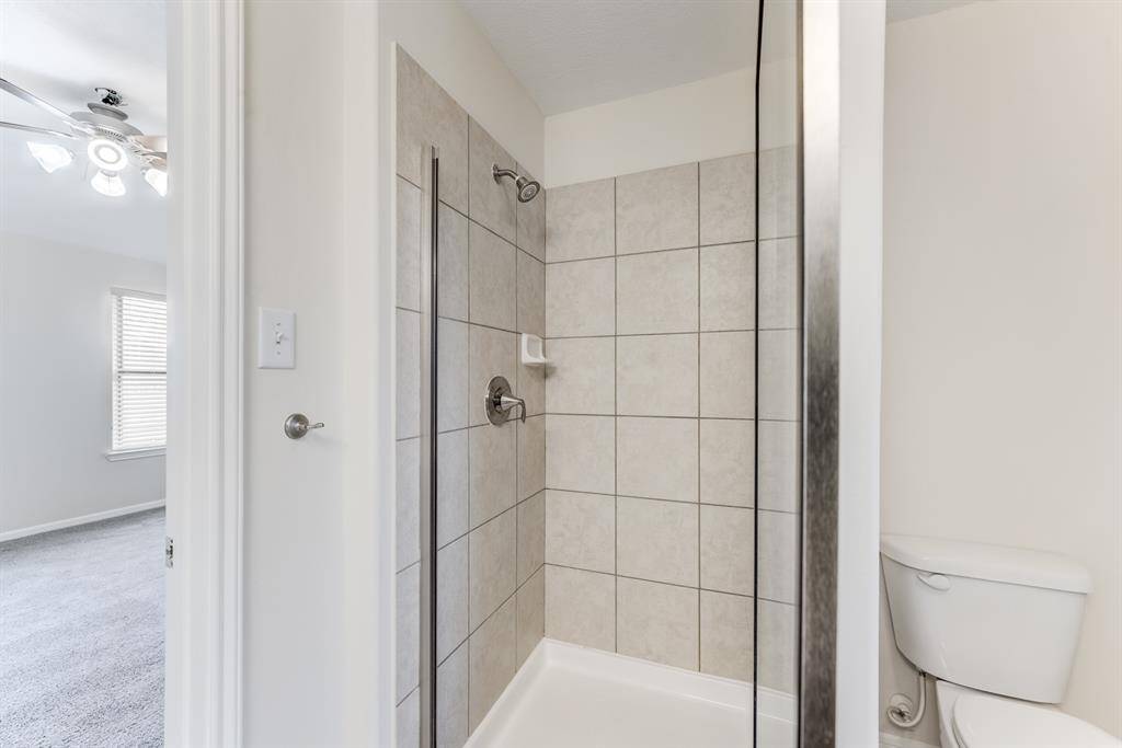 Primary Bathroom – Shower ViewWalk-in shower with modern tile surround and updated fixtures, located just off the primary bedroom.