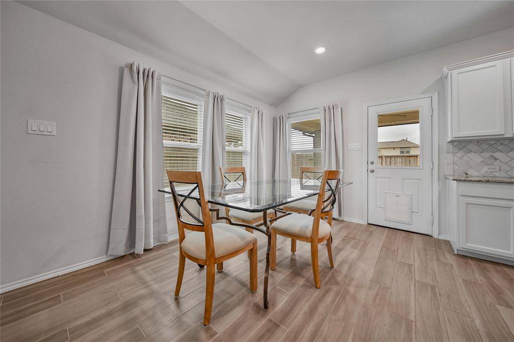 The Kitchen is a Dream with Granite Counters, Center Island, and Accenting White Cabinets.