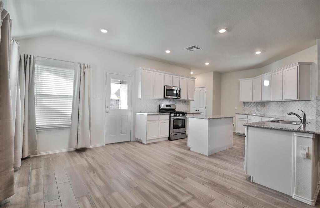 The Breakfast / Dining Area Offers Lots of Space and Easily Fits a Dining Sized Table.
