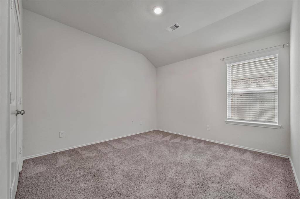 Secondary Bedroom 3 Offers High Ceilings and a Lovely Window with Front Yard Views.