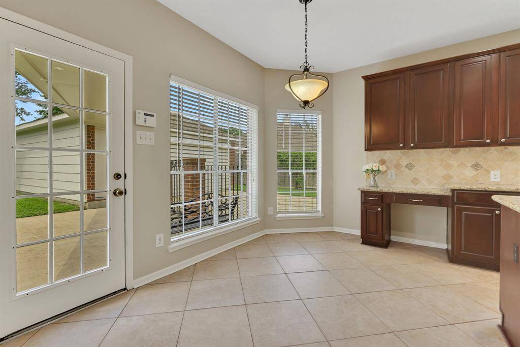 Bright breakfast room open to the kitchen with convenient access to the backyard.