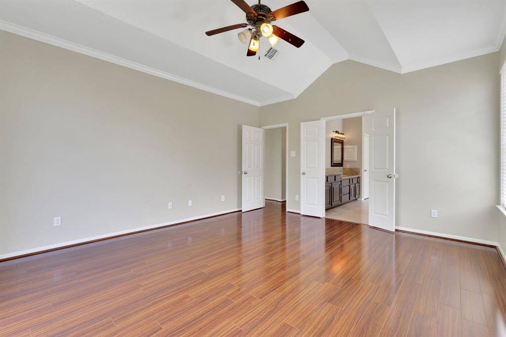 Another view of the primary suite, featuring double doors that lead to your private primary bath.
