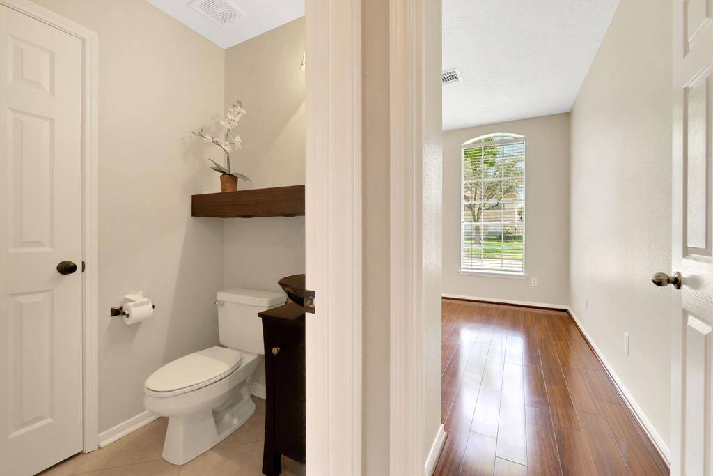 Half bath located between the home office and living room, offering convenience and privacy for guests.