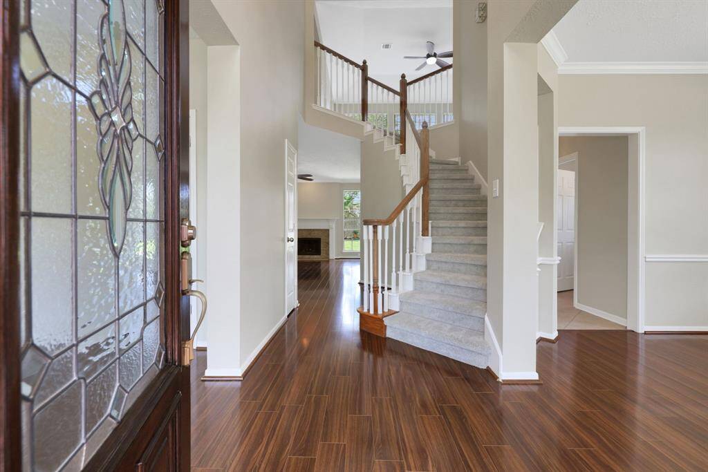 Stunning entryway features a grand staircase and soaring high ceilings that create an impressive first impression.