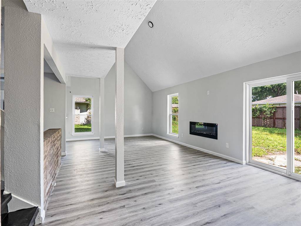 Bright and inviting living room with brand-new flooring, perfect for relaxing or entertaining guests.