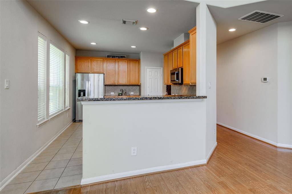 Kitchen with breakfast bar open to the Living Room