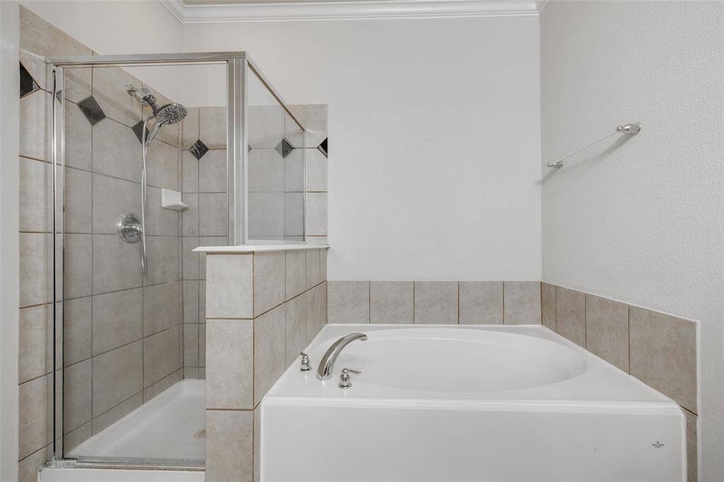 Primary bathroom with walk-in closet, separate shower & tub.