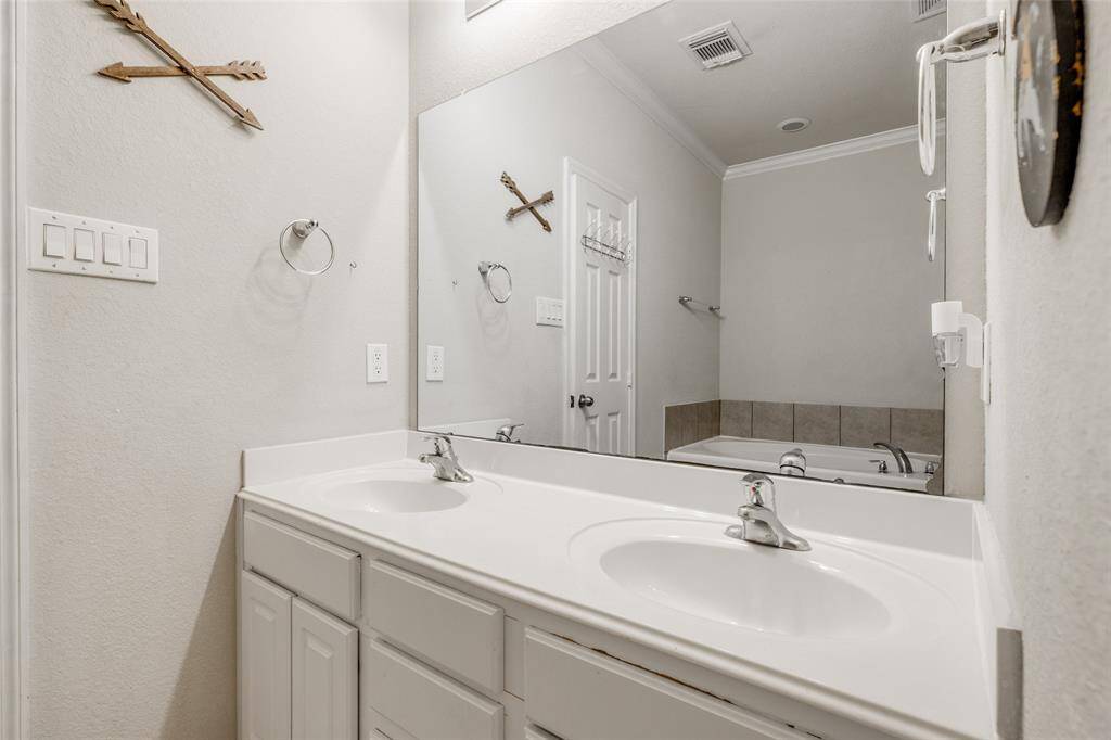 Primary bathroom with walk-in closet, separate shower & tub & double vanities