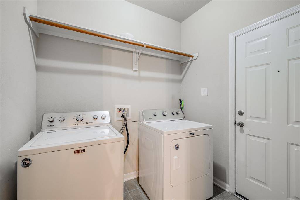 Utility room with washer & dryer, door to the garage