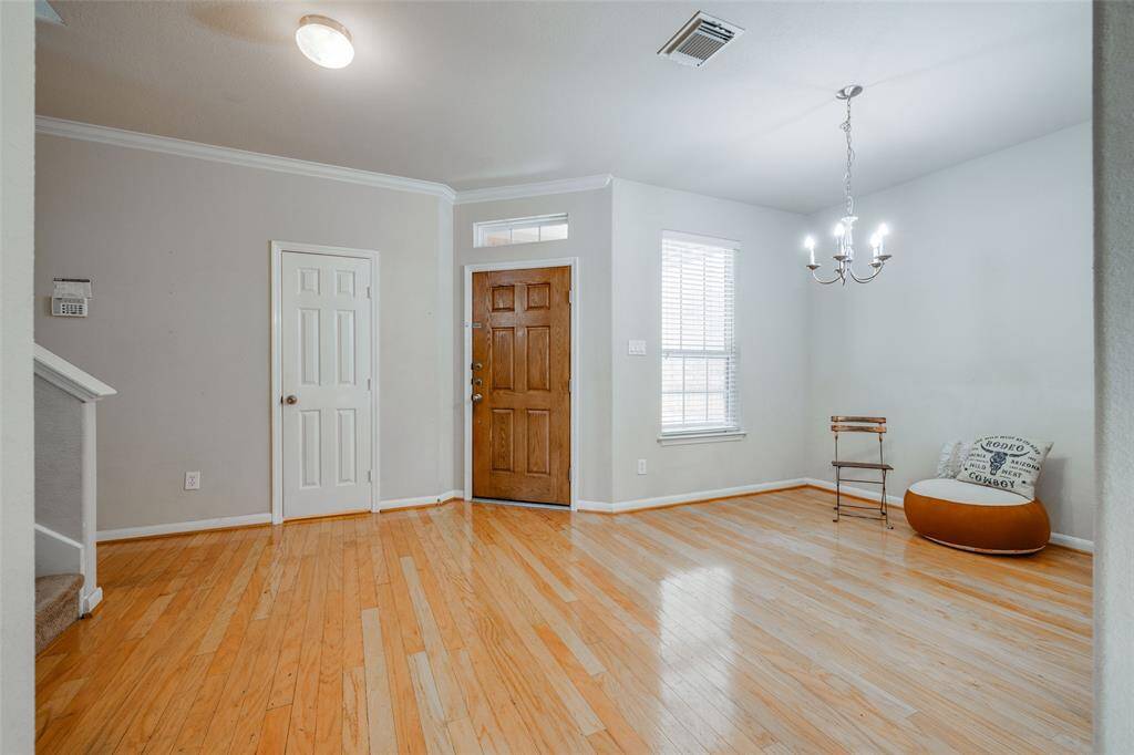 Wood floors as you enter into this Townhome with formal dining area, chandelier and half bath.