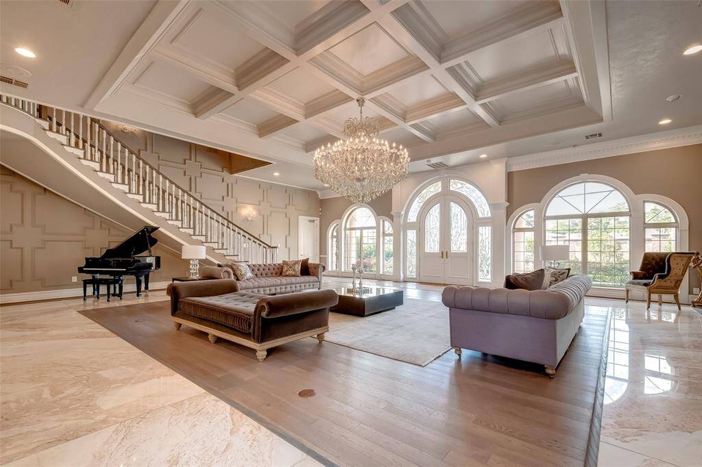 Luxurious grand room perfect for entertaining, featuring exquisite coffered ceilings.