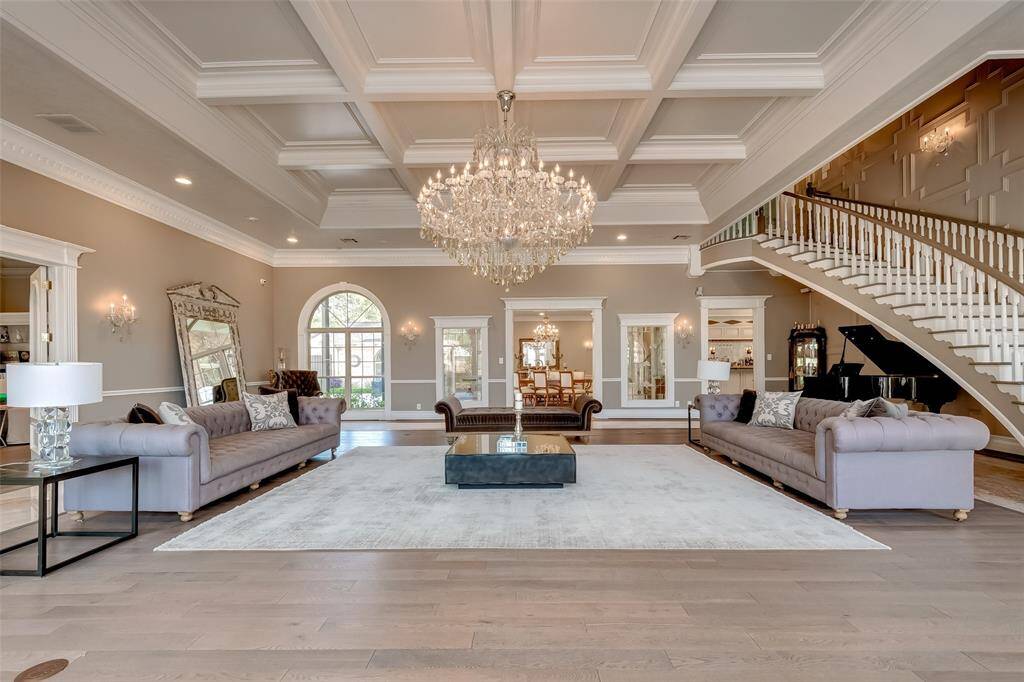 Experience elegance with a unique, grand chandelier illuminating the spacious room.