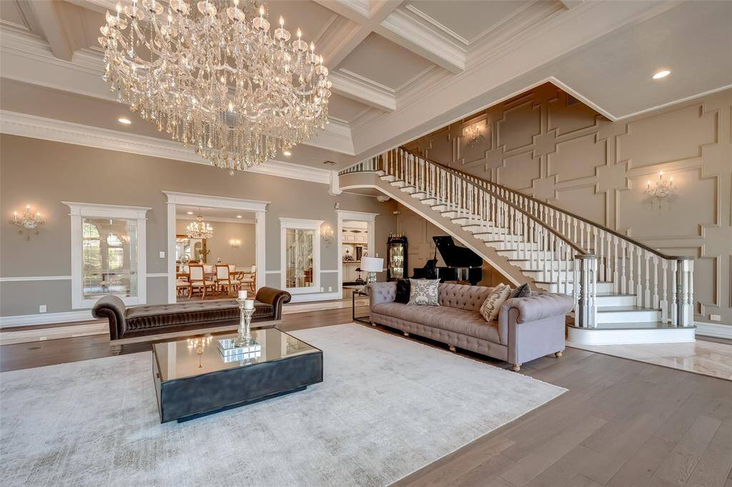 This elegant home features a grand room and dining area beautifully divided by stunning stained glass.
