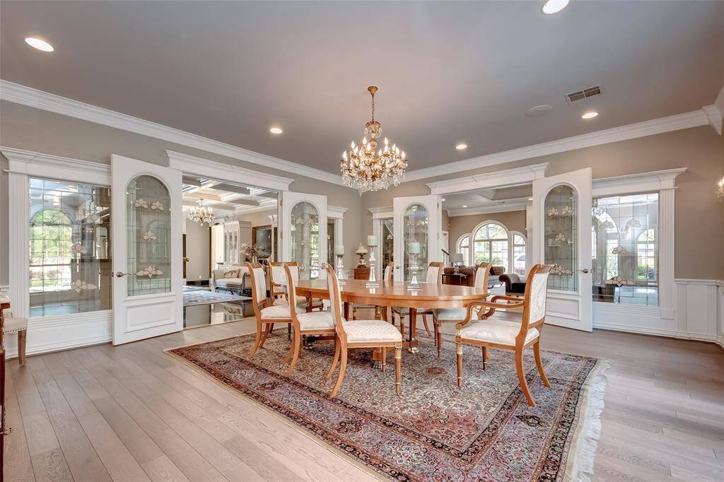 Bright dining room with a window offering views of the pool and lush backyard.