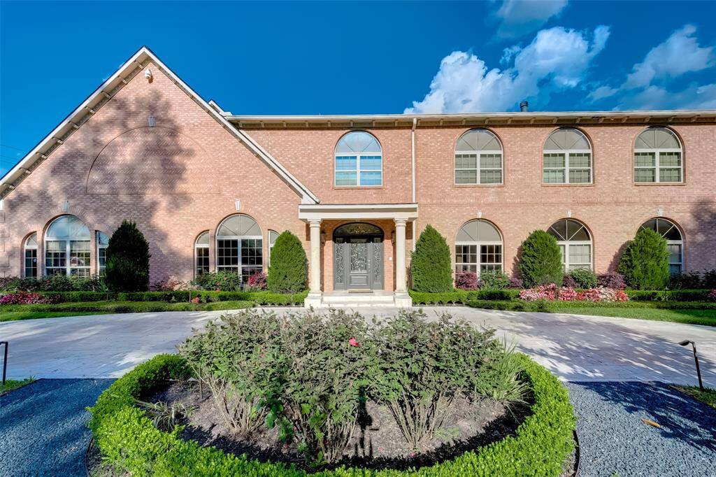 Elegant circular driveway with a convenient second entrance enhances accessibility and curb appeal.