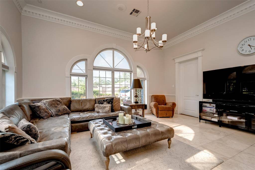Cozy and elegant kitchen sitting area featuring ample natural light, plush seating, and a stylish chandelier—perfect for relaxing or entertaining.