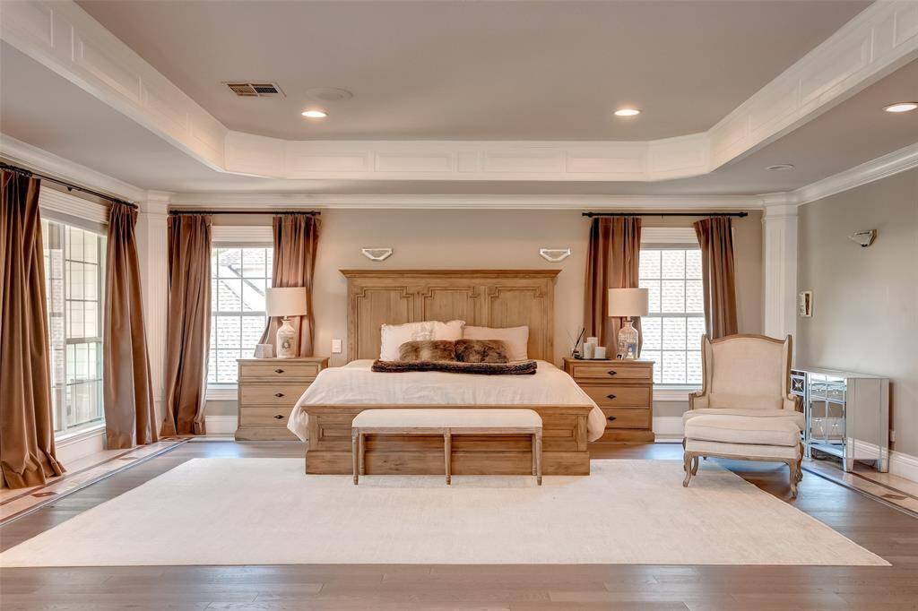 Bright master bedroom with abundant natural light and expansive windows.