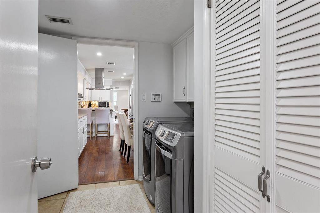 Looking from the utility room towards the kitchen. Access to the garage is to the left. On the other side of this utility room you will find a full bathroom that has access to the pool