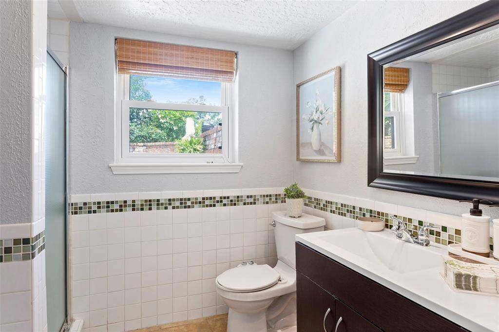 Third full bathroom with shower. This bathroom has direct access to the pool area. Perfect to keep those wet swimmers out of the main areas of the home or have guests shower before entering the pool.