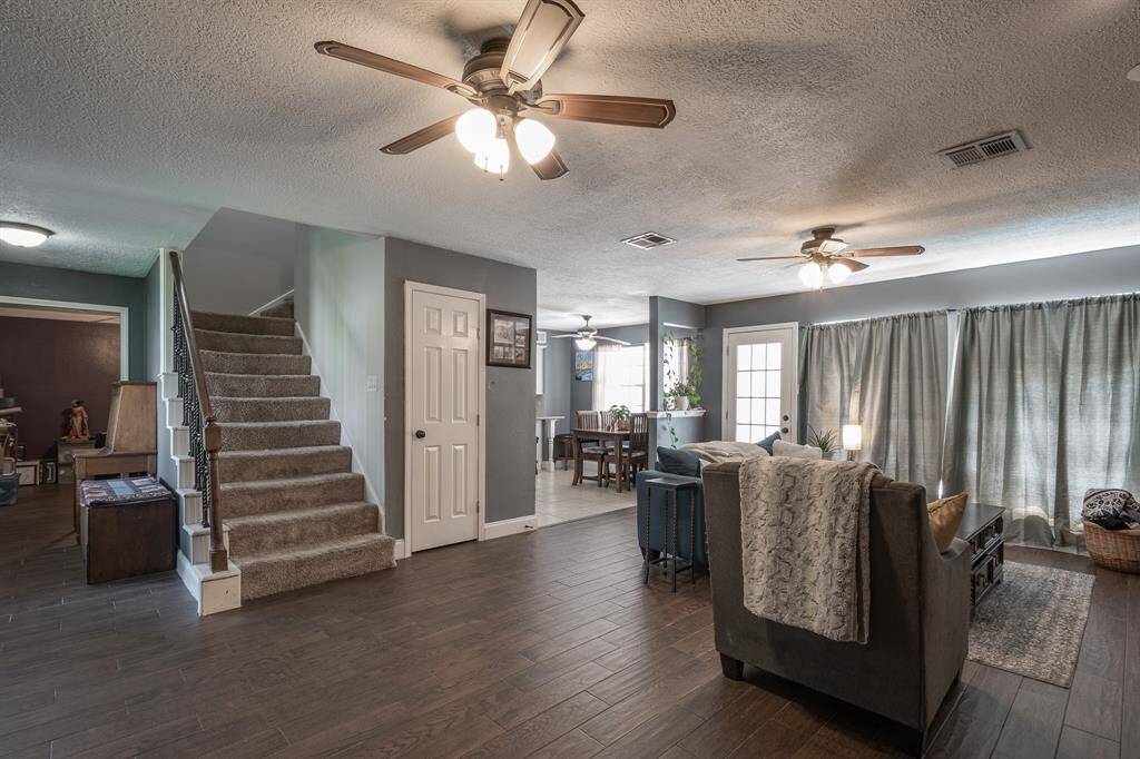 View going upstairs, looking into the living room and breakfast area.