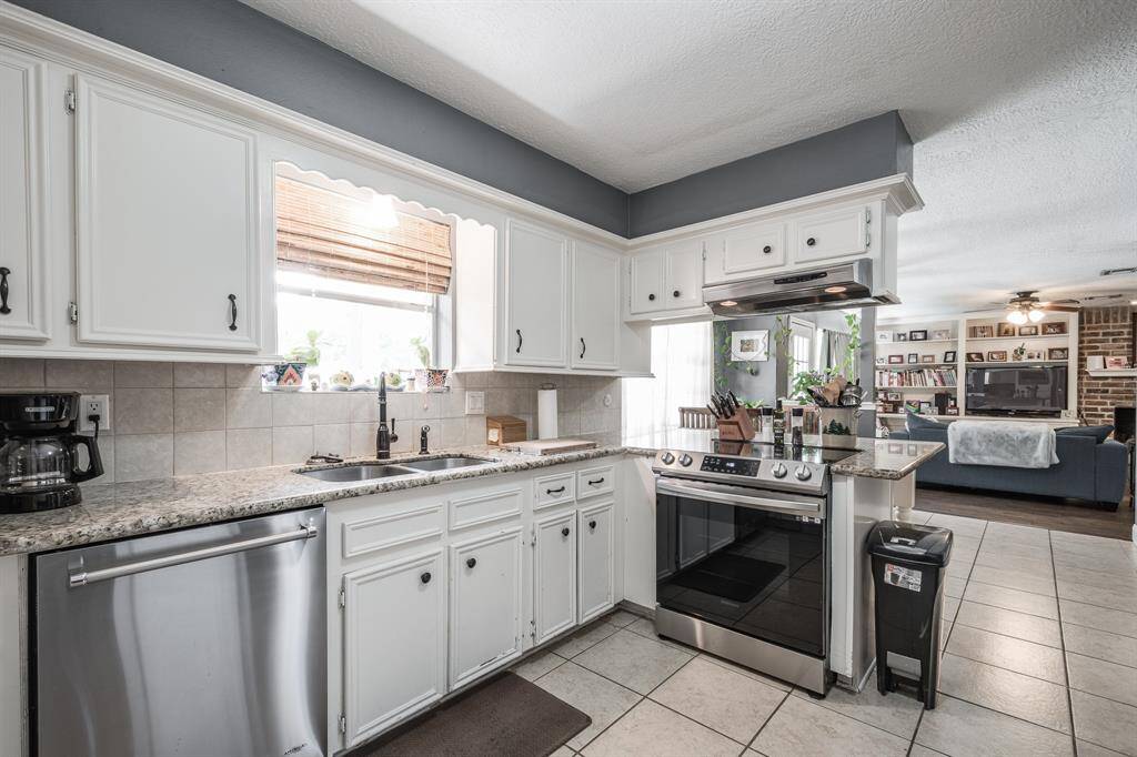Kitchen open to breakfast and living room area.