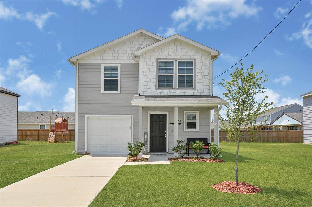 This charming two-story home features a modern gray exterior with white trim, a single-car garage, and a welcoming front porch. The front yard is well-maintained with a small tree and neat landscaping.