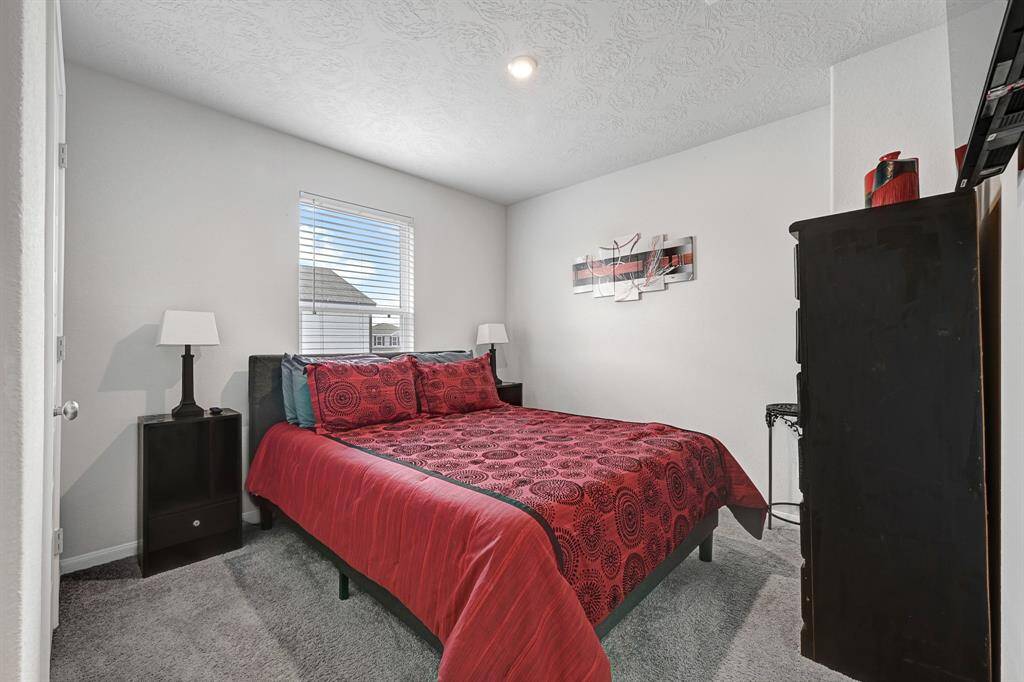 Another cozy secondary bedroom with ample space for double bed & furniture.  The carpeted floor and neutral walls create a comfortable atmosphere.